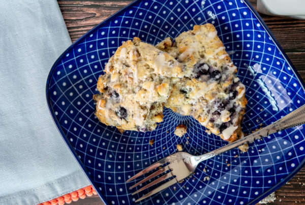 Blueberry Scones on a plate with a fork and napkin nearby.