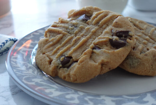 Two PB Chocolate Chip Cookies on a plate.