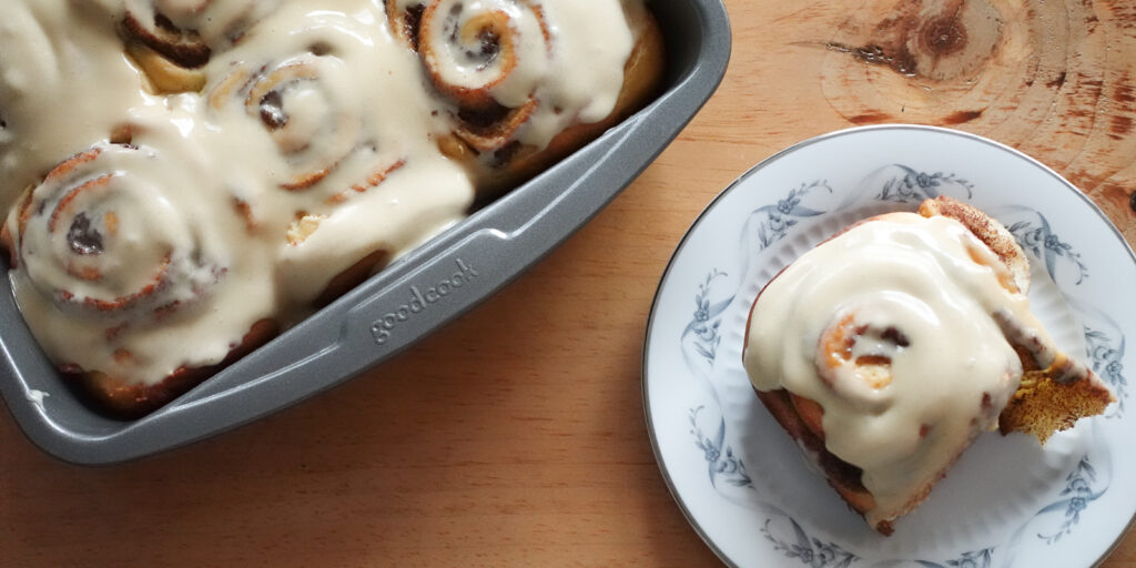 Cinnamon Rolls in a tray and on a plate.