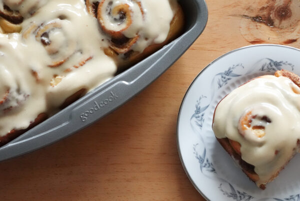 Cinnamon Rolls in a tray and on a plate.