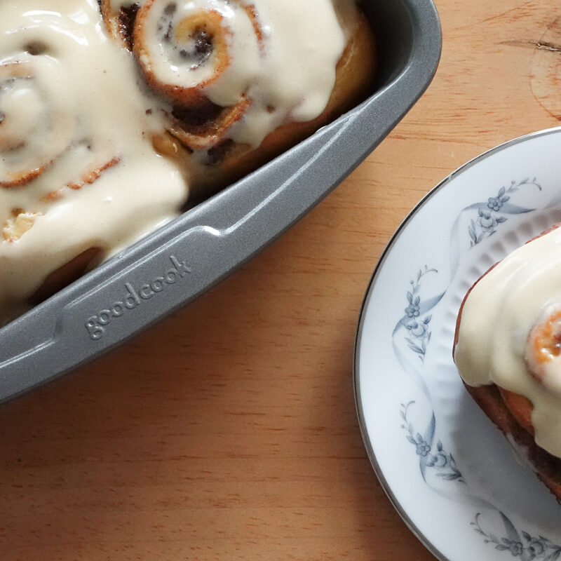 Cinnamon Rolls in a tray and on a plate.