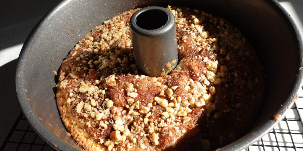 Sour Cream Coffee Cake with Crumble Topping in a 10" tube pan fresh from the oven.