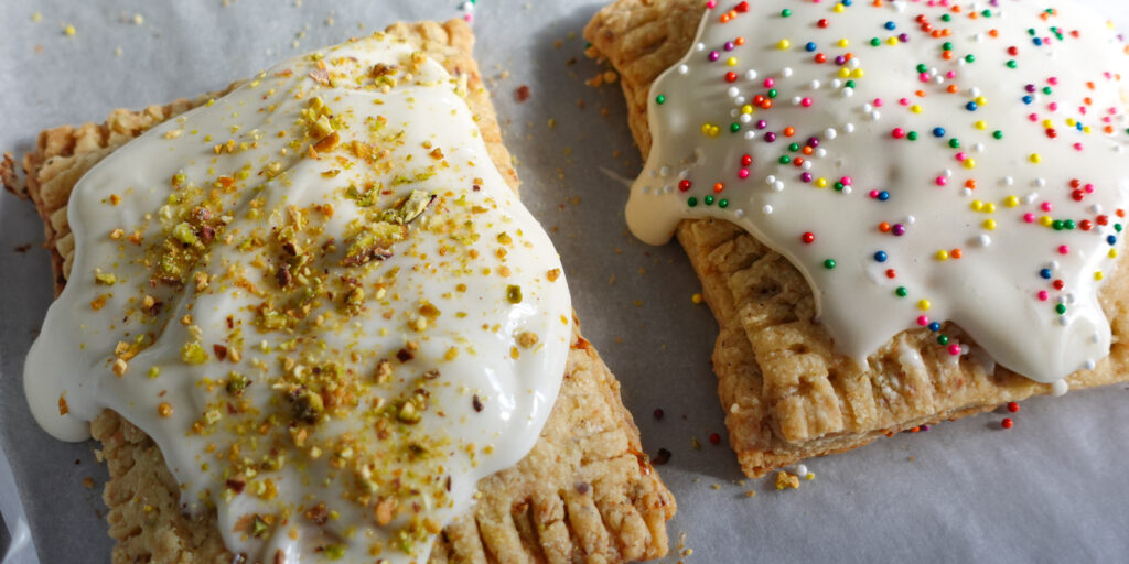 Strawberry-Cherry Pistachio Pop Tarts on a baking sheet.