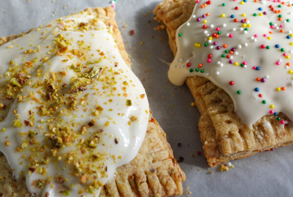 Strawberry-Cherry Pistachio Pop Tarts on a baking sheet.