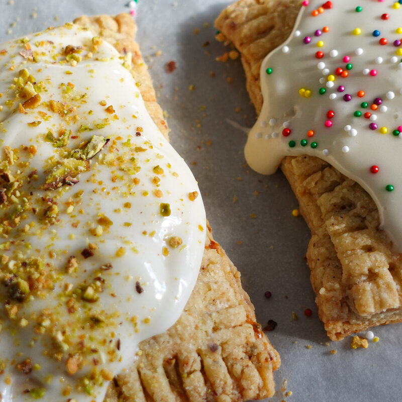 Strawberry-Cherry Pistachio Pop Tarts on a baking sheet.