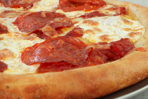 Pizza fresh from oven with a thick crust.