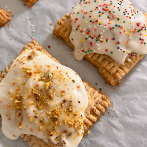 Strawberry-Cherry Pistachio pop tarts on a baking sheet.