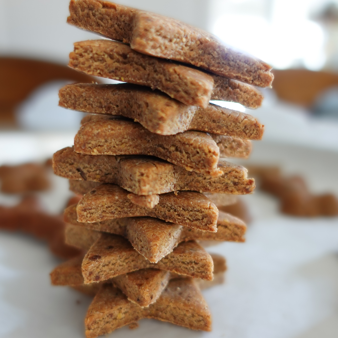 A stack of peanut butter flaxseed cookies for dogs.