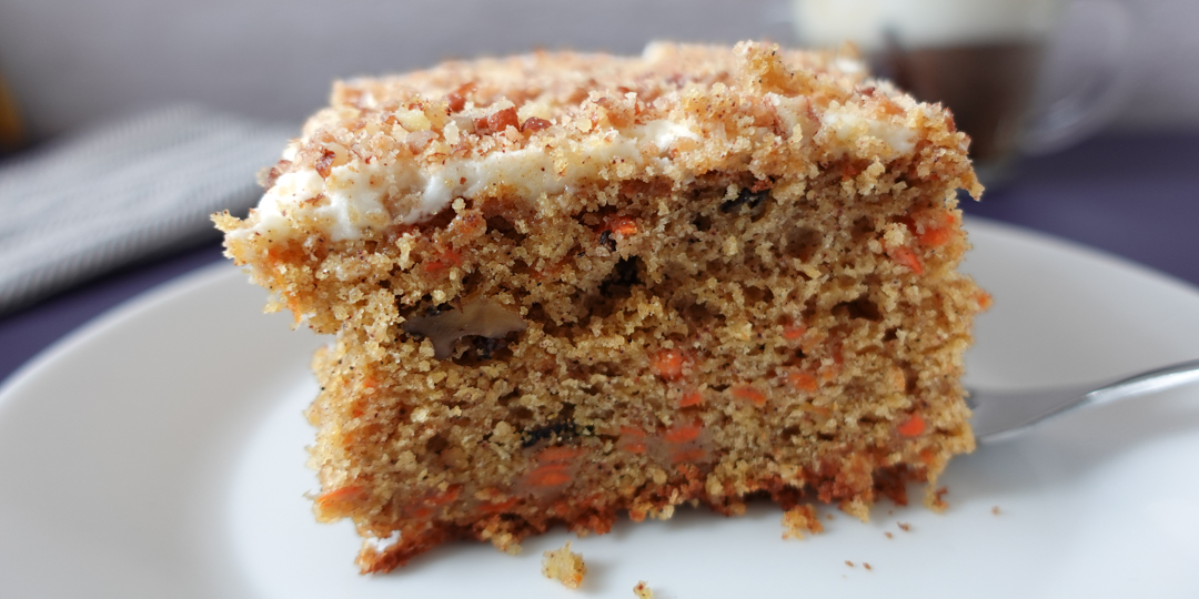 This is an image of carrot cake on a white plate.