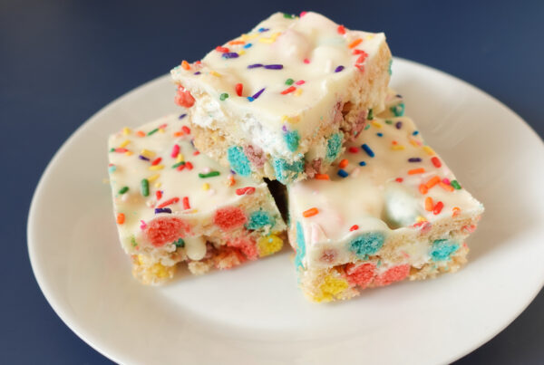 This is an image of Rice Krispie Treats Cereal Birthday Bars on a white plate.