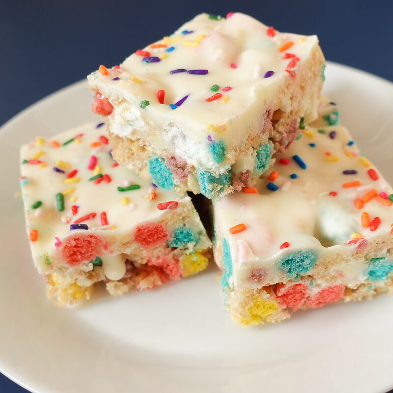 This is an image of Rice Krispie Treats Cereal Birthday Bars on a white plate.