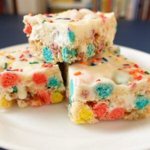 An image of rice krispie treats cereal birthday bars on a white plate.