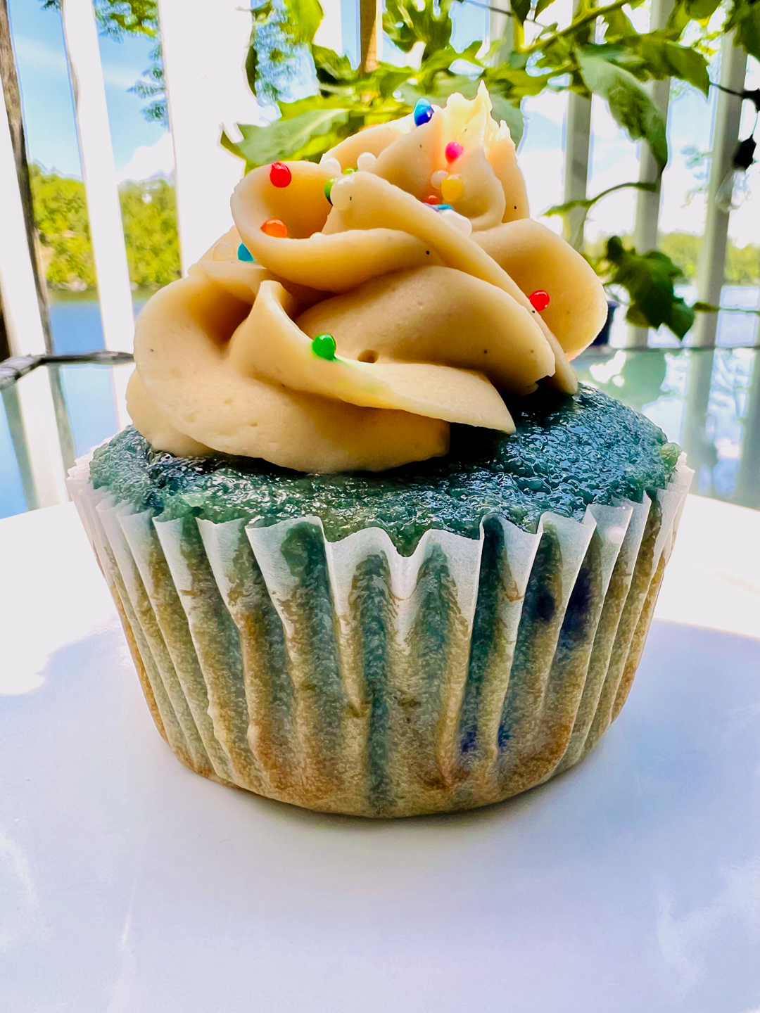 This is an image of a Blueberry Pancake Cupcake on a white plate.