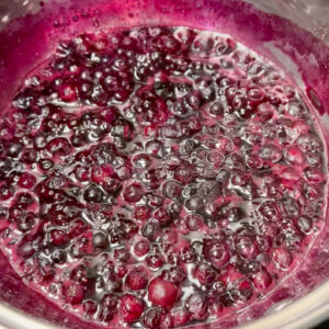 This is an image of the blueberry sauce during the last minute of boiling.