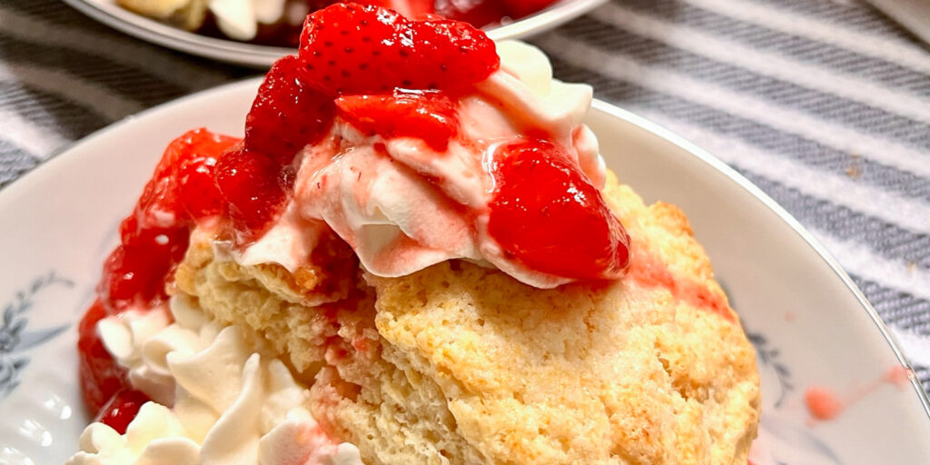 Strawberry Shortcake on a white plate on top of a kitchen towel.