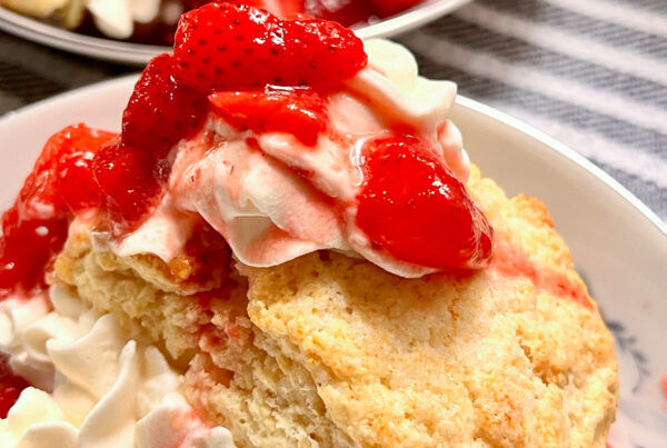 Strawberry Shortcake on a white plate on top of a kitchen towel.