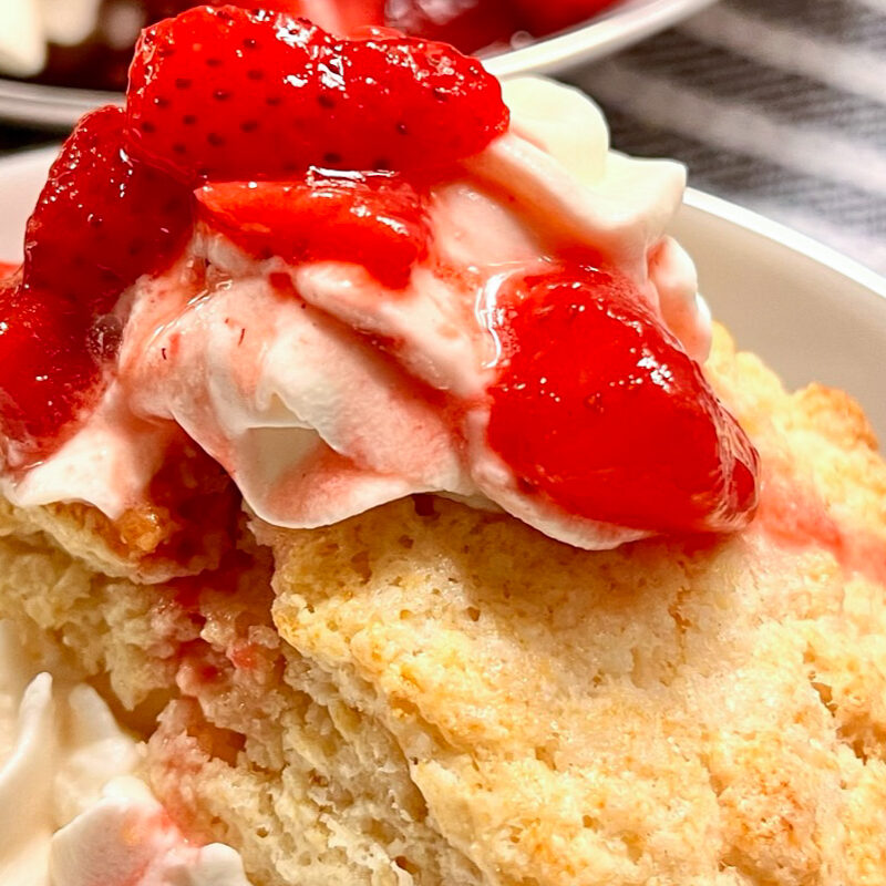 Strawberry Shortcake on a white plate on top of a kitchen towel.