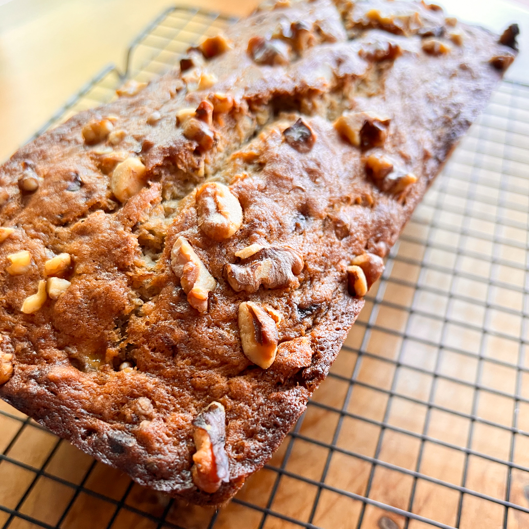 Vegan Banana Bread loaf cooling on a rack.